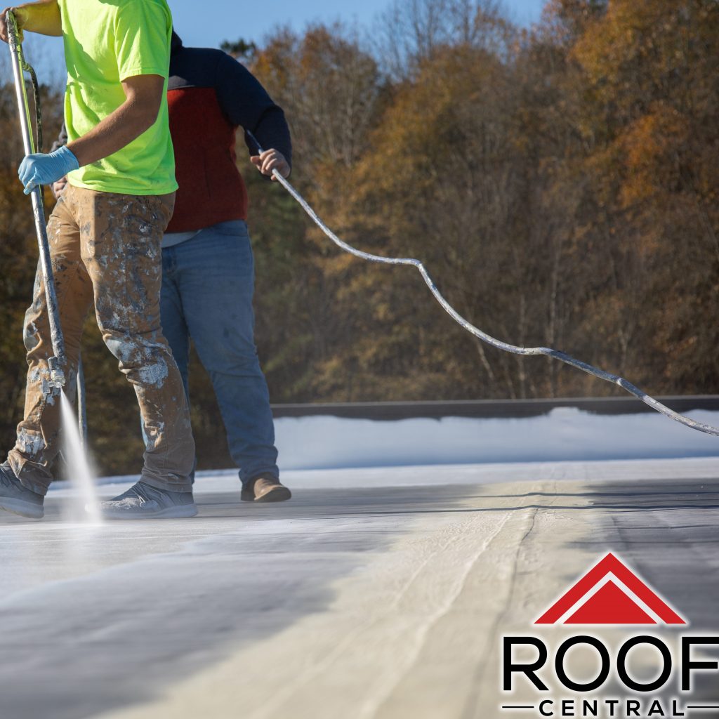 Workers finishing up a top layer of a commercial roof coating. 