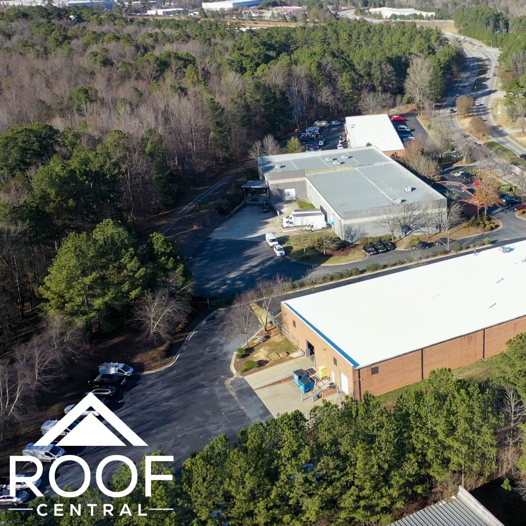 A picture of a building with a while cool roof placed on it. 