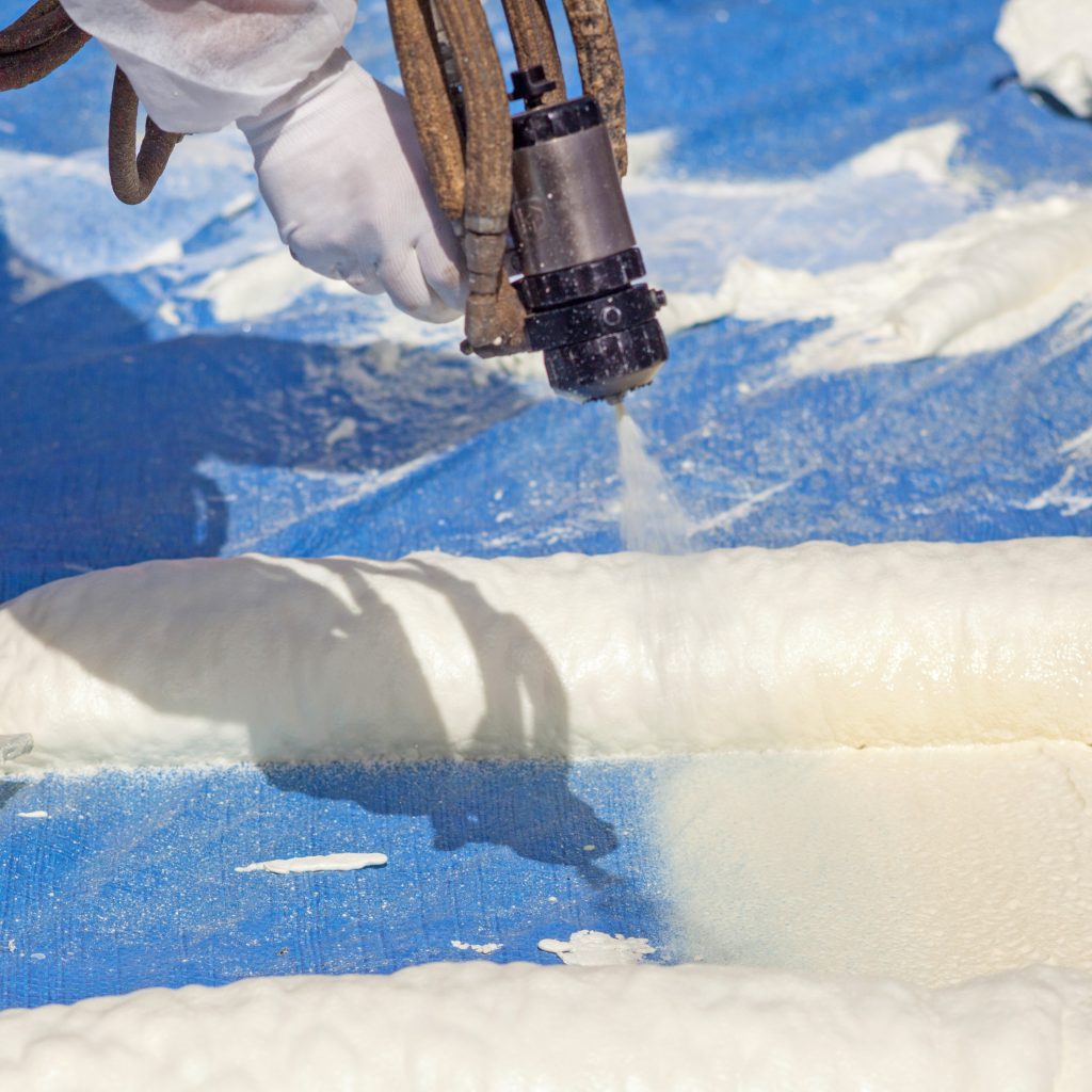 SPF foam being sprayed on a building. 