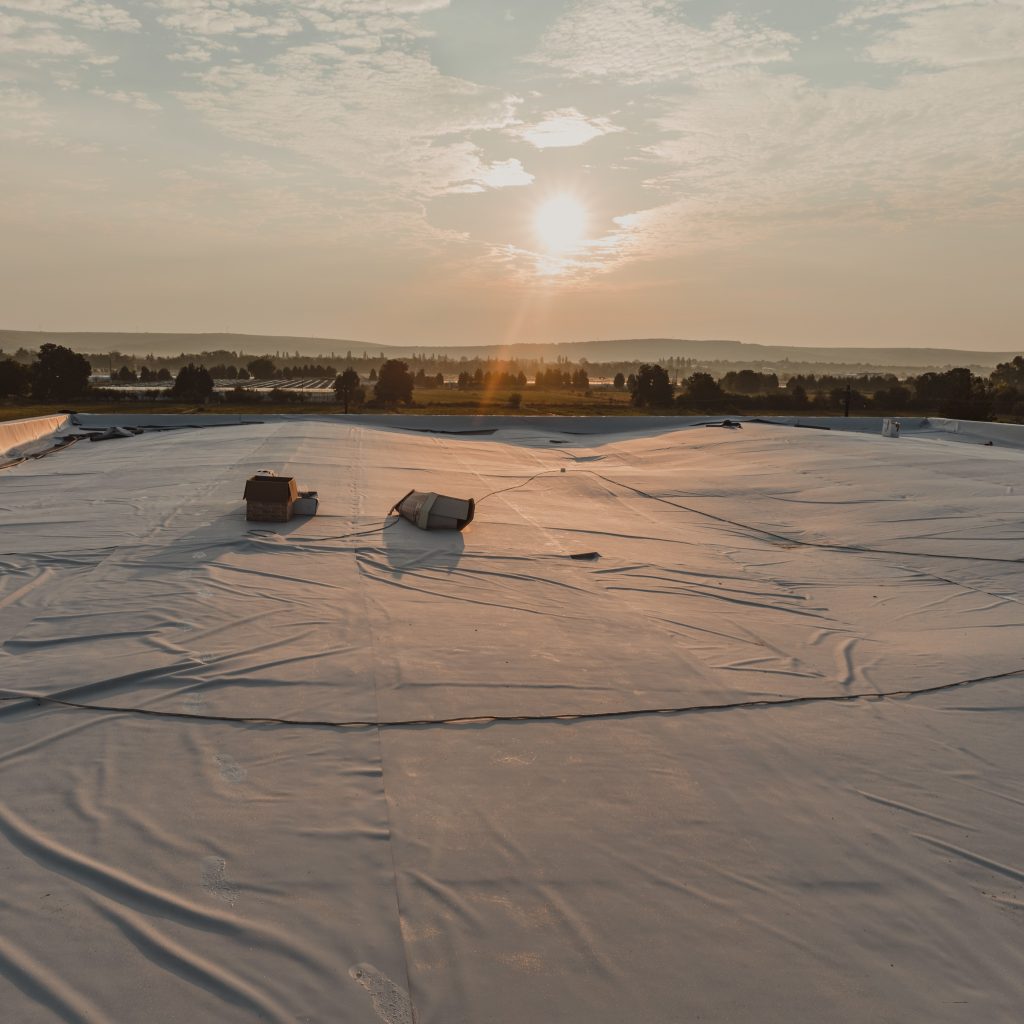 TPO membrane laid on top of a building during the installation process.