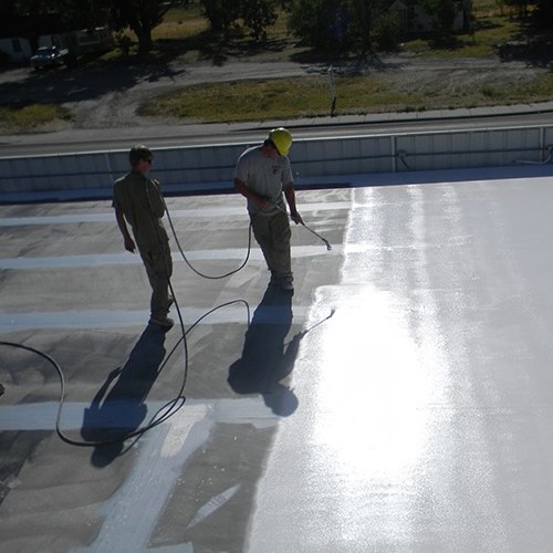 Contractors apply an acrylic coating.